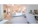 Bright main bedroom boasts a tray ceiling, ceiling fan, and adjacent dressing area at 2247 Pink Hawthorn Dr, Buford, GA 30518