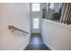 A bright stairwell featuring wood-look floors, modern railings, and a door that brings in natural light at 2247 Pink Hawthorn Dr, Buford, GA 30518