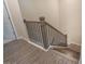Detailed view of a staircase featuring hardwood steps and decorative black wrought iron spindles at 2247 Pink Hawthorn Dr, Buford, GA 30518