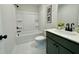 Clean bathroom features a shower-tub combo, modern vanity, and elegant hexagonal tile flooring at 304 Marigold Ln, Woodstock, GA 30188