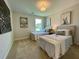 Bright bedroom with twin beds, neutral tones, and decorative wall art creates a serene and inviting atmosphere at 304 Marigold Ln, Woodstock, GA 30188