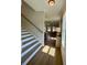 Inviting hallway featuring a wooden staircase and an open view into the living and kitchen areas at 304 Marigold Ln, Woodstock, GA 30188