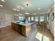 Open-concept kitchen boasts a large island with pendant lighting and stainless steel appliances at 304 Marigold Ln, Woodstock, GA 30188