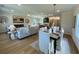Open-concept living room with dining area, comfortable seating, and gas fireplace at 304 Marigold Ln, Woodstock, GA 30188