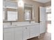 Bright bathroom features double sinks, white cabinetry, updated fixtures, and tile floors at 3725 Crescent Walk Ln, Suwanee, GA 30024