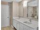 Dual sinks and quartz countertop in the luxurious bathroom with white cabinets at 3725 Crescent Walk Ln, Suwanee, GA 30024