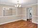 Formal dining area with hardwood floors and elegant lighting, great for hosting dinner parties at 3725 Crescent Walk Ln, Suwanee, GA 30024