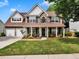 Charming two-story home featuring a stone facade, well-manicured lawn and a welcoming front porch at 3725 Crescent Walk Ln, Suwanee, GA 30024