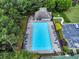 Aerial view of a community pool with lounge chairs, clubhouse, parking, and surrounding greenery at 3725 Crescent Walk Ln, Suwanee, GA 30024