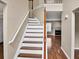 Inviting staircase featuring hardwood treads, white risers, and a traditional wooden banister at 3725 Crescent Walk Ln, Suwanee, GA 30024
