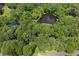 Secluded home with large trees, a pond, and long driveway offers natural privacy from the street and neighbors at 3957 Evans Drive Dr, Lithia Springs, GA 30122