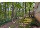 Lush backyard with mature trees and a deck, perfect for outdoor entertaining and relaxation at 3957 Evans Drive Dr, Lithia Springs, GA 30122