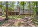 A spacious backyard featuring a deck, walk-out basement, lush greenery, and mature trees at 3957 Evans Drive Dr, Lithia Springs, GA 30122