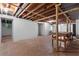 Spacious unfinished basement with exposed beams and a workbench at 3957 Evans Drive Dr, Lithia Springs, GA 30122