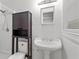 Bright bathroom featuring a pedestal sink and enclosed shower at 3957 Evans Drive Dr, Lithia Springs, GA 30122