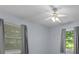 Bedroom with a ceiling fan, gray curtains and two windows with outdoor views at 3957 Evans Drive Dr, Lithia Springs, GA 30122
