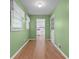 Hallway that leads to the kitchen with hardwood style flooring and white trim at 3957 Evans Drive Dr, Lithia Springs, GA 30122