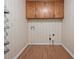 Functional laundry room with overhead cabinets and striped wallpaper at 3957 Evans Drive Dr, Lithia Springs, GA 30122