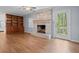 Cozy living room featuring a brick fireplace, built-in shelves, and laminate floors at 3957 Evans Drive Dr, Lithia Springs, GA 30122