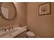 Bathroom with a round framed mirror, a white vanity and toilet with neutral walls at 1622 Rivergreen Se Bnd # 26, Atlanta, GA 30339