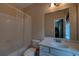 Neutral bathroom featuring shower-tub combo with white vanity and large mirror reflecting the doorway at 1622 Rivergreen Se Bnd # 26, Atlanta, GA 30339