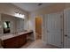 Bathroom with dual vanity, granite countertop, dark cabinets, and large mirror at 1622 Rivergreen Se Bnd # 26, Atlanta, GA 30339