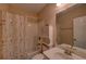 Bathroom features shower-tub, single vanity, white toilet, and decorative shower curtain at 1622 Rivergreen Se Bnd # 26, Atlanta, GA 30339