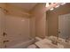 Bright bathroom boasts white fixtures, a shower-tub combination, and a large mirror at 1622 Rivergreen Se Bnd # 26, Atlanta, GA 30339