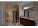 Bathroom with glass shower, vanity with dark wood cabinets, granite countertops and a large mirror at 1622 Rivergreen Se Bnd # 26, Atlanta, GA 30339