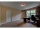 Bedroom with neutral walls, carpet flooring, a window for natural light, and a desk at 1622 Rivergreen Se Bnd # 26, Atlanta, GA 30339