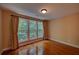 This bedroom features hardwood floors, large windows with curtains, and natural light at 1622 Rivergreen Se Bnd # 26, Atlanta, GA 30339