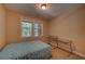 Bedroom featuring neutral walls, carpet floors, a window for natural light, and a twin bed with 2 desks at 1622 Rivergreen Se Bnd # 26, Atlanta, GA 30339