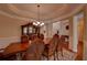 Elegant dining room with tray ceiling, chandelier, and large dining table at 1622 Rivergreen Se Bnd # 26, Atlanta, GA 30339
