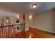 The upstairs hallway includes beautiful hardwood floors, fireplace and a view of the downstairs living space at 1622 Rivergreen Se Bnd # 26, Atlanta, GA 30339