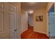 Hallway with hardwood floors, white doors, neutral walls, and a staircase in the background at 1622 Rivergreen Se Bnd # 26, Atlanta, GA 30339