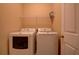 Laundry room featuring a front load washer and dryer, shelf, and a white door at 1622 Rivergreen Se Bnd # 26, Atlanta, GA 30339