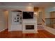 A cozy living room with a fireplace, built-in shelves and gleaming hardwood floors provides charm and function at 1622 Rivergreen Se Bnd # 26, Atlanta, GA 30339