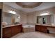 Main bathroom features a soaking tub, separate vanities with dark wood cabinets and neutral countertop at 1622 Rivergreen Se Bnd # 26, Atlanta, GA 30339