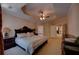The primary bedroom with a tray ceiling and ceiling fan provides a luxurious space with plenty of room at 1622 Rivergreen Se Bnd # 26, Atlanta, GA 30339