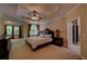 The primary bedroom features a tray ceiling, ceiling fan, and large windows, creating a light-filled retreat at 1622 Rivergreen Se Bnd # 26, Atlanta, GA 30339