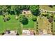 Tranquil aerial view of an expansive green backyard with lush landscaping, towering trees, and a charming patio area at 3819 Courson St, Marietta, GA 30066