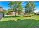 Expansive backyard featuring lush green lawn, mature trees, and a charming garden area, ideal for outdoor enjoyment at 3819 Courson St, Marietta, GA 30066
