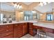 Bathroom featuring double vanity with makeup table and large mirrors, wood cabinets at 3819 Courson St, Marietta, GA 30066
