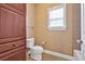 Well-lit half bath features a toilet, tiled floors, vanity, and a window for natural light at 3819 Courson St, Marietta, GA 30066
