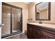 Bathroom featuring a glass enclosed shower, vanity with dark cabinets, and a framed mirror at 3819 Courson St, Marietta, GA 30066