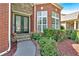 Close-up of brick entrance and well manicured bushes and mulch bed around front door at 3819 Courson St, Marietta, GA 30066