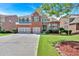 Beautiful brick home featuring a three-car garage and well-manicured lawn at 3819 Courson St, Marietta, GA 30066