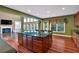 Kitchen featuring an island with cooktop and view to a living room with fireplace and built-ins at 3819 Courson St, Marietta, GA 30066