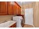Well-equipped laundry room featuring wood cabinets and modern washer and dryer at 3819 Courson St, Marietta, GA 30066