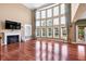 Spacious living room featuring fireplace, hardwood floors, large windows & curtains at 3819 Courson St, Marietta, GA 30066